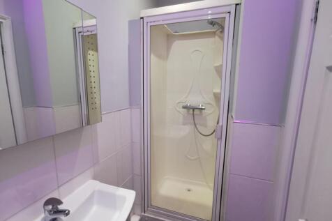 Modern bathroom with sleek shower and mirror ca...