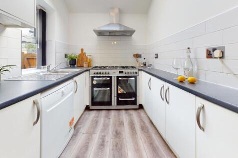 A bright and modern kitchen with ample space an...