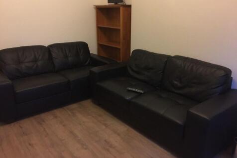 Comfortable living room with two black leather ...