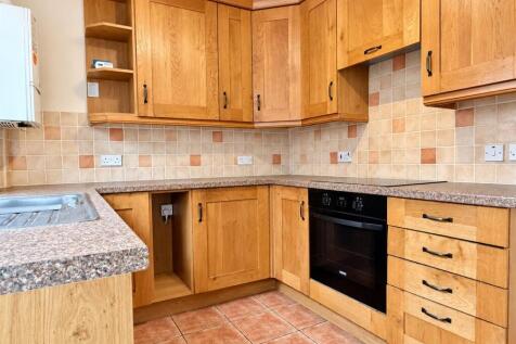 warm_oak_kitchen_corner_with_tiled_backsplash.jpg
