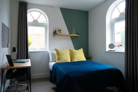 A stylish and well-lit double bedroom featuring...