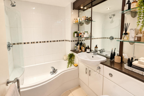 Modern White-Tiled Bathroom with Botanical Accents