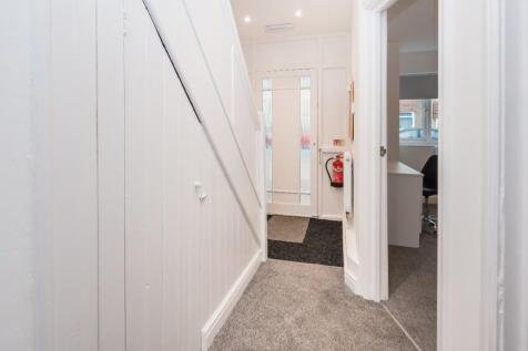 Bright, freshly painted hallway with white pane...