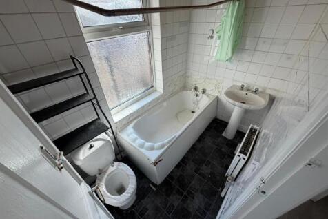 Bright bathroom suite with bath and storage...