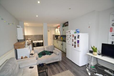 A spacious living room featuring a comfortable ...