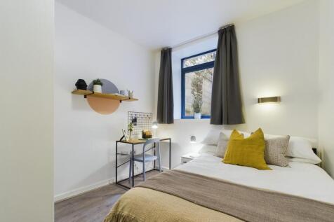 A bright and inviting double bedroom featuring ...