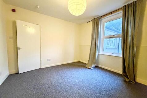 Spacious bedroom with window and clean carpet...