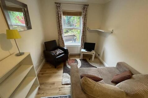Cosy lounge with wood flooring and natural ligh...