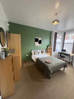 A stylish double bedroom featuring a cozy doubl...