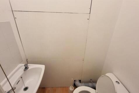Compact, well-kept bathroom with a wall-mounted...