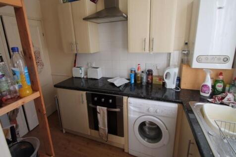 Compact fitted kitchen with matching wall and b...