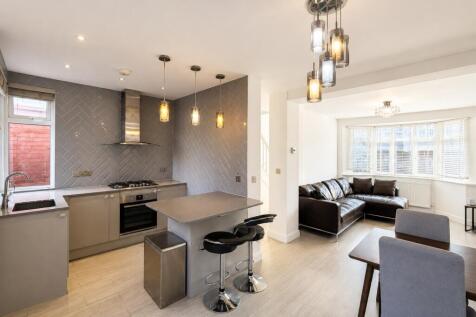 Modern open-plan kitchen with breakfast bar...