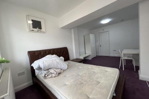 Bright, newly painted bedroom with a large leat...