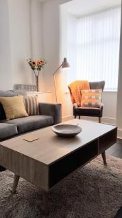 Bright, stylish lounge with a cozy reading nook...