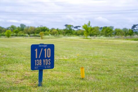 Golf course tee marker on open green at Birchingto