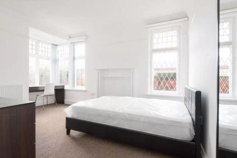 Bright, airy bedroom with large bay windows, cl...