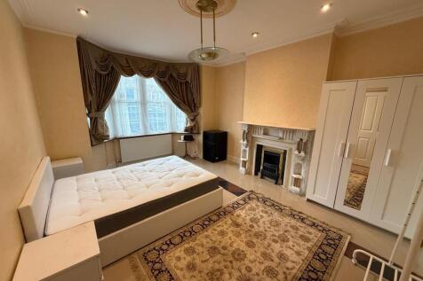 Bright master bedroom with elegant bay window...