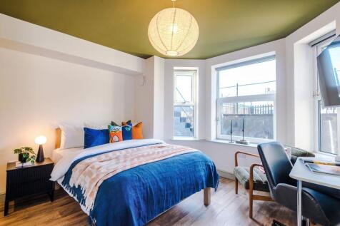 Bright, stylish bedroom with a comfortable doub...