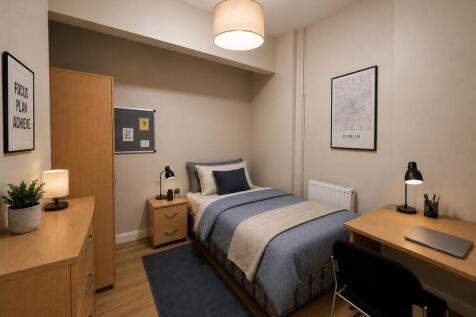 Sleek bedroom with desk and ample storage space...