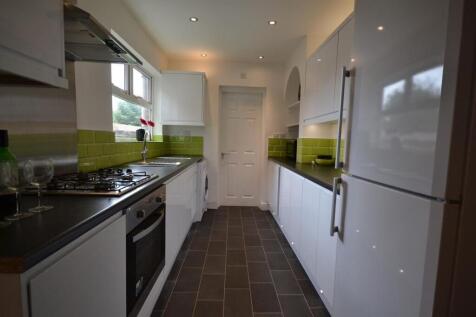 Modern kitchen with sleek white cabinets....