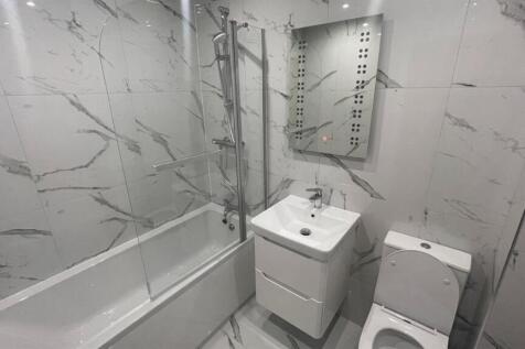 Contemporary bathroom with marble-effect wall t...