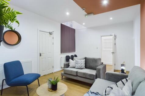 A welcoming and spacious living room with moder...