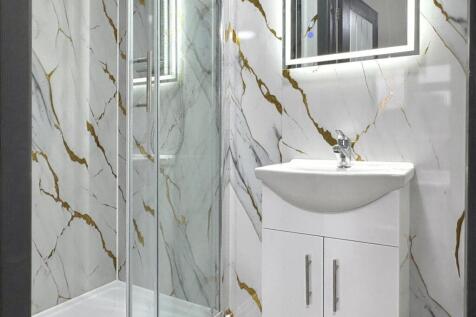 Contemporary bathroom with marble-effect wall t...