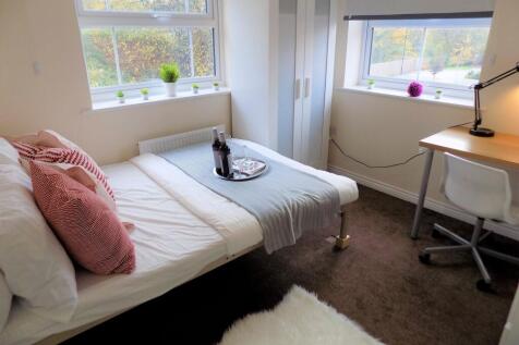 Bright, neatly furnished single bedroom with a ...