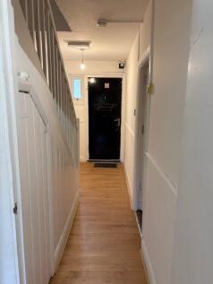 Bright hallway with warm wooden flooring...
