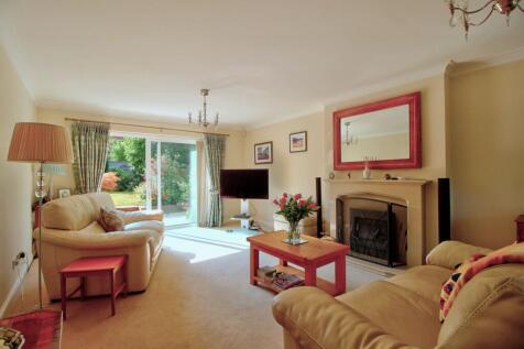 Living room with patio doors and bay window