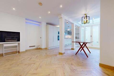 Bright open plan living space with wooden floor...