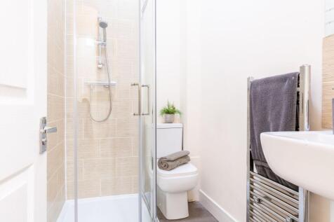 Bright, modern bathroom with a walk-in shower, ...