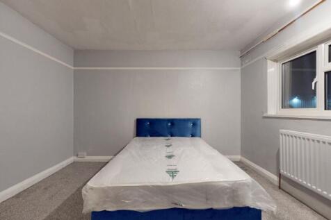 Bright and spacious double bedroom featuring a ...