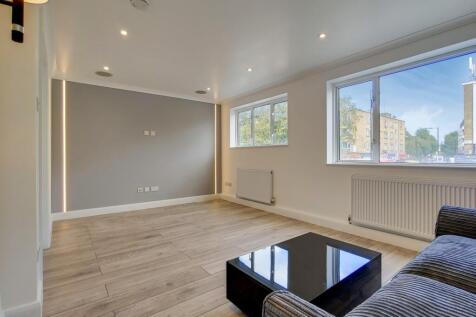 Bright modern lounge with sleek wood flooring...