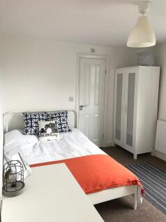 Bright, tidy double bedroom with a white bed, m...