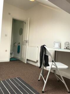 Bright, simply furnished single bedroom with a ...