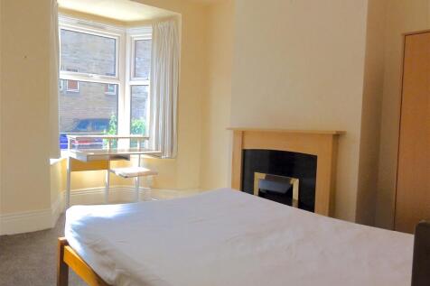 Bright and welcoming bedroom featuring a comfor...