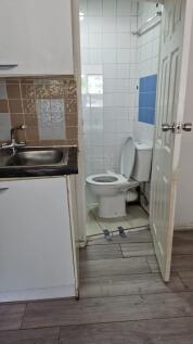 Bright tiled bathroom with functional layout....