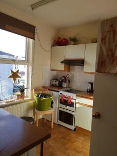 Sunny compact kitchen with large window, fitted...