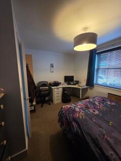 Well-appointed double bedroom with a cozy bed d...