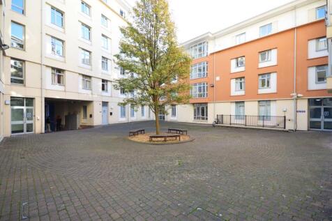 Bright central courtyard with seating and tree...