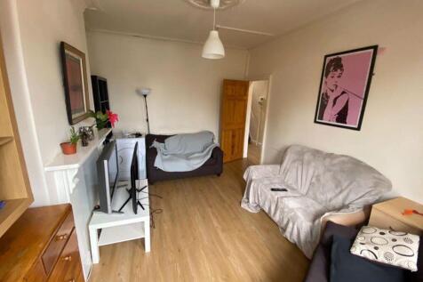 A bright and welcoming living room featuring co...