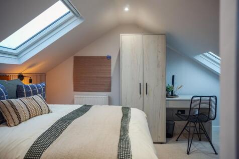 Cozy attic bedroom with skylights and desk...