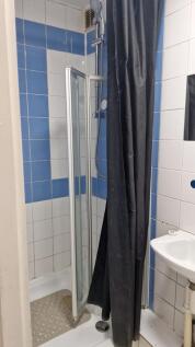 Clean shower with modern blue and white tiling....