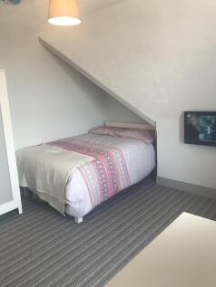Cozy bedroom with a double bed and modern TV...