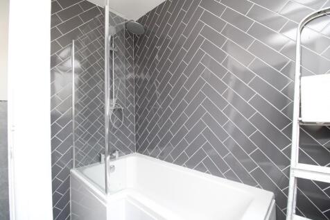 Modern bathroom with chic grey herringbone tile...