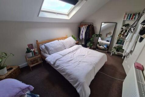 A bright and inviting master bedroom featuring ...