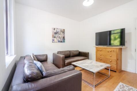 A bright and inviting living room featuring two...