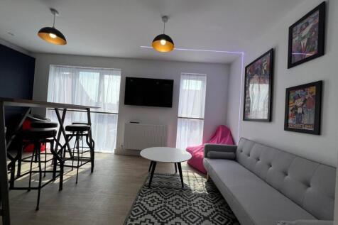 Bright modern living room with a comfy grey sof...
