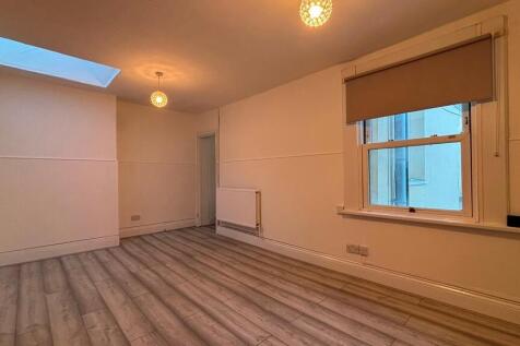 Spacious modern lounge with bright skylight...